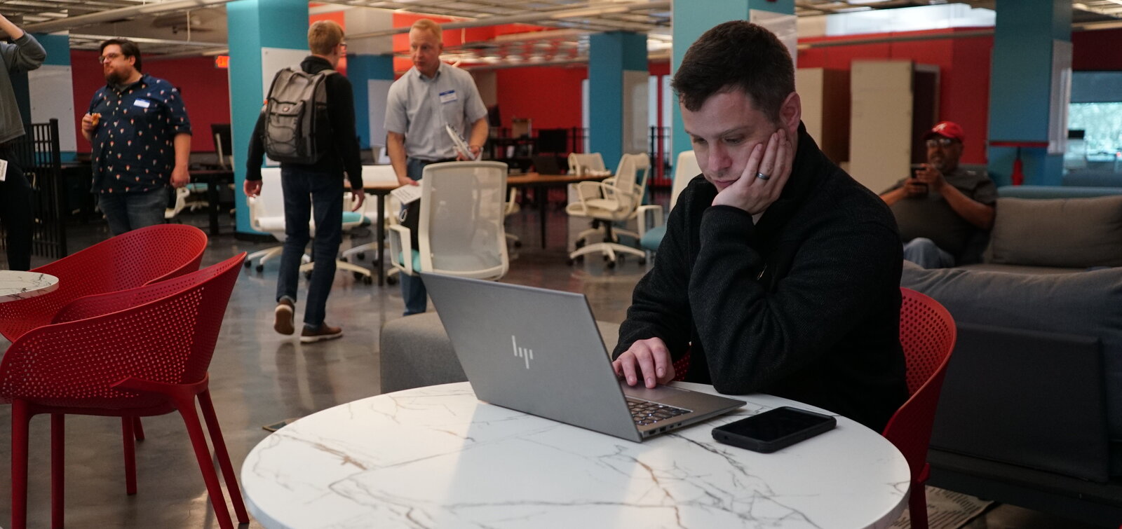 Member focused on laptop work